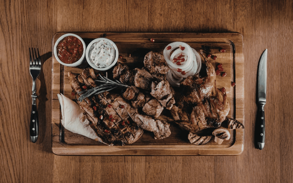 Cocinero preparando carne a la brasa en Mollet del Vallès en cocina profesional